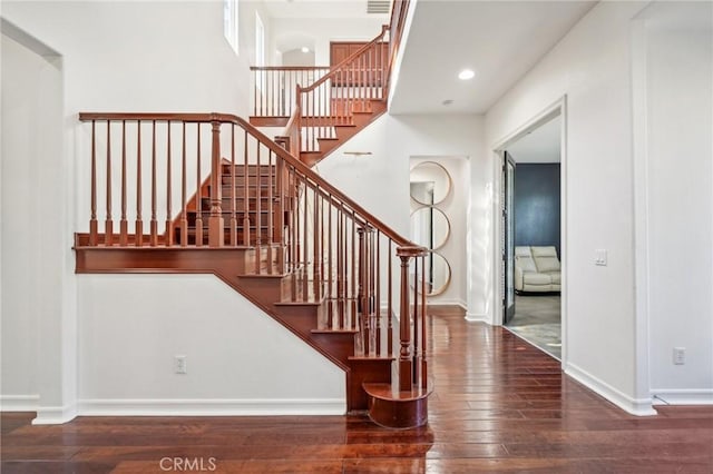 stairway featuring wood-type flooring