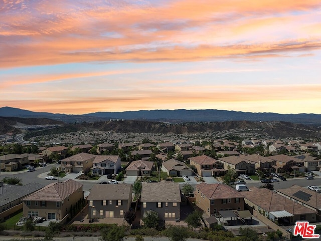 aerial view at dusk featuring a mountain view