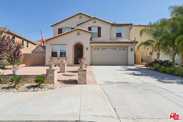 mediterranean / spanish-style home featuring a garage