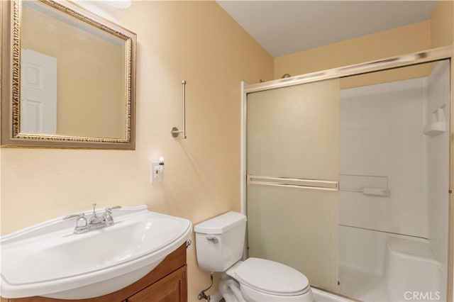 bathroom featuring walk in shower, vanity, and toilet