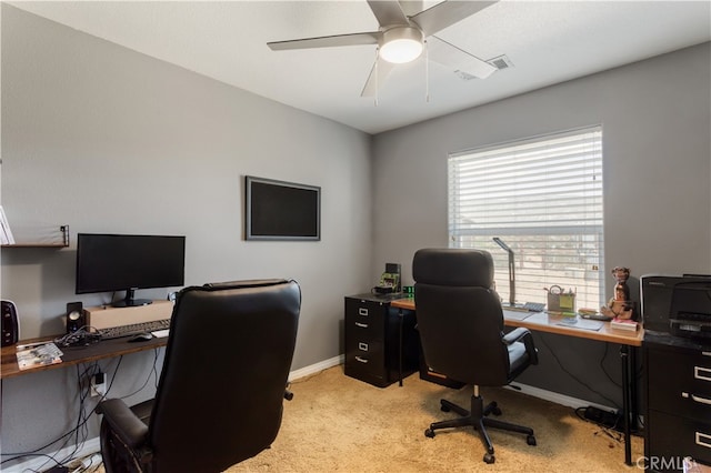 carpeted home office featuring ceiling fan