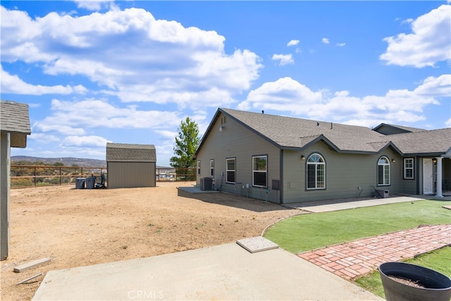 view of front of home with a storage unit and central air condition unit