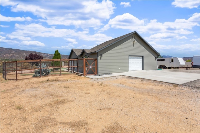 exterior space with a mountain view and a garage