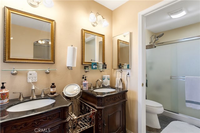 bathroom with tile patterned flooring, an enclosed shower, vanity, and toilet