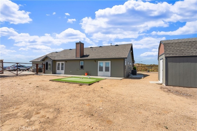 back of property featuring cooling unit, a storage shed, and a patio area