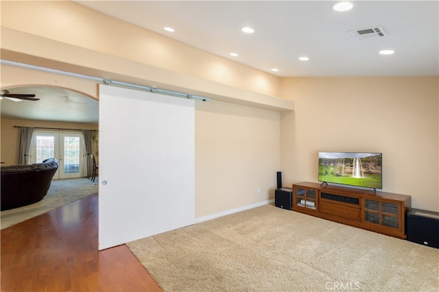 basement with ceiling fan, french doors, and hardwood / wood-style floors