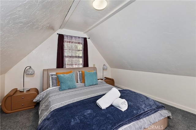 carpeted bedroom with a textured ceiling and vaulted ceiling