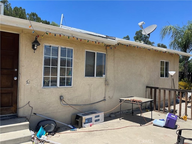 view of side of home with a patio area