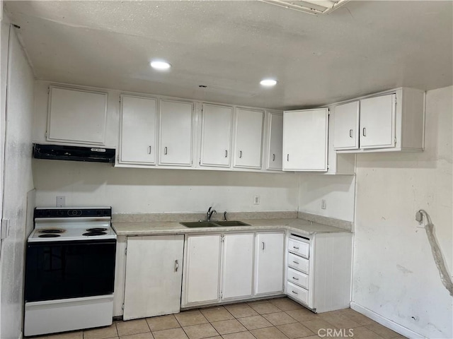 kitchen featuring white electric range, light tile patterned floors, white cabinetry, and sink