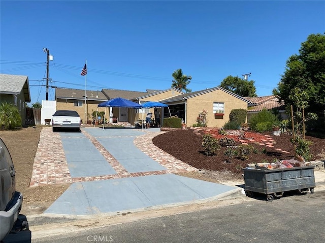 single story home featuring driveway and stucco siding