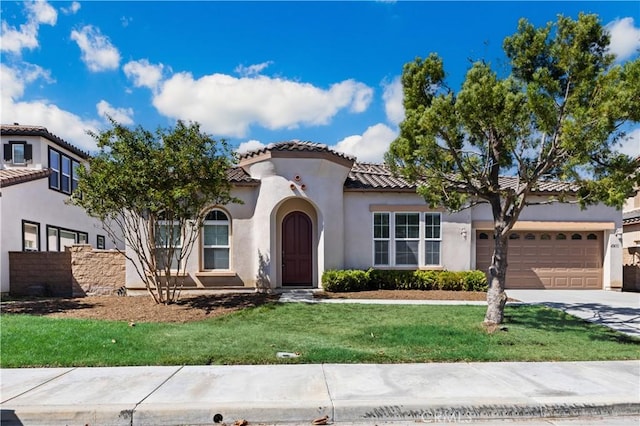 mediterranean / spanish-style house with a garage and a front lawn