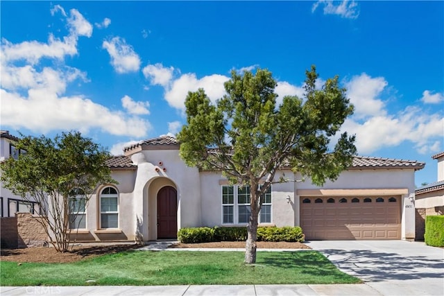 mediterranean / spanish house with a garage