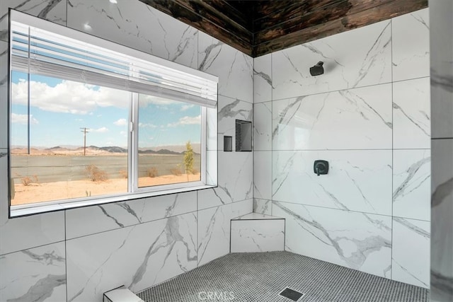 bathroom with tiled shower