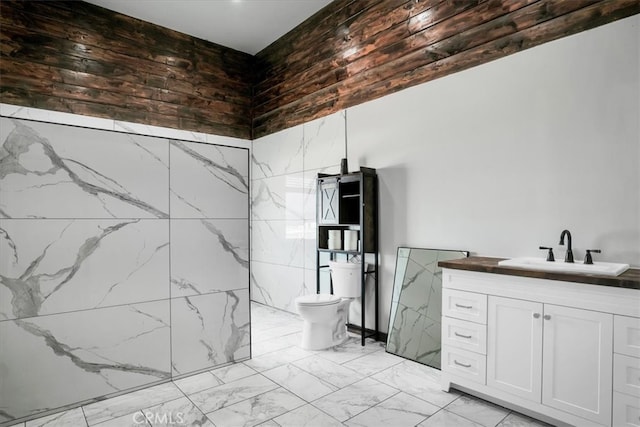 bathroom featuring tile walls, vanity, and toilet