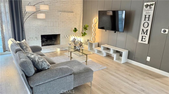 living room featuring hardwood / wood-style flooring and a fireplace