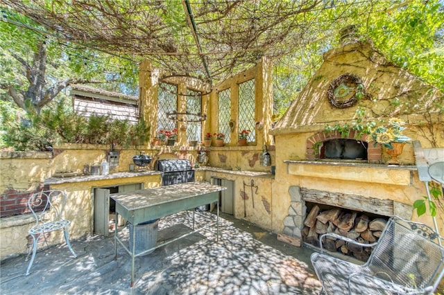 view of patio with an outdoor stone fireplace