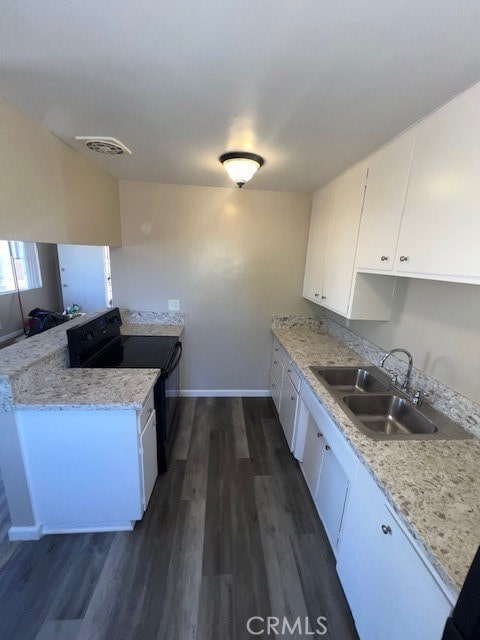 kitchen featuring black range with electric cooktop, white cabinetry, dark hardwood / wood-style flooring, and sink