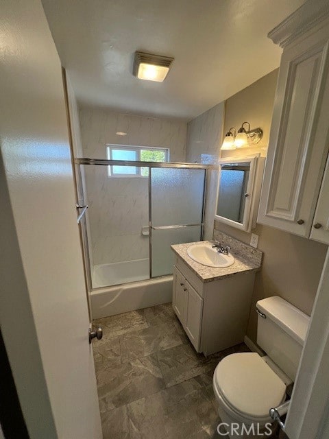 full bathroom featuring enclosed tub / shower combo, vanity, and toilet