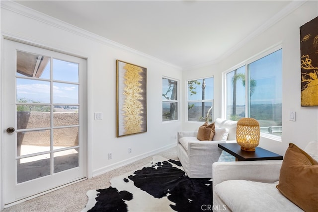 sitting room featuring ornamental molding, carpet, and a wealth of natural light