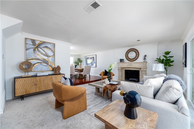 carpeted living room with crown molding and a premium fireplace