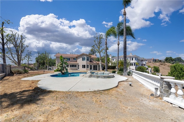 view of pool with a patio and an in ground hot tub