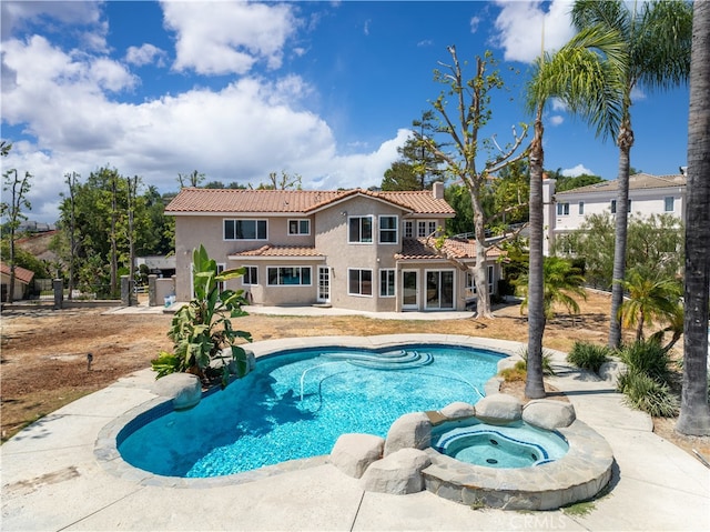 view of pool with an in ground hot tub and a patio area