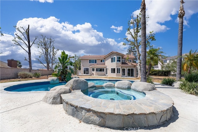 view of pool with an in ground hot tub and a patio area