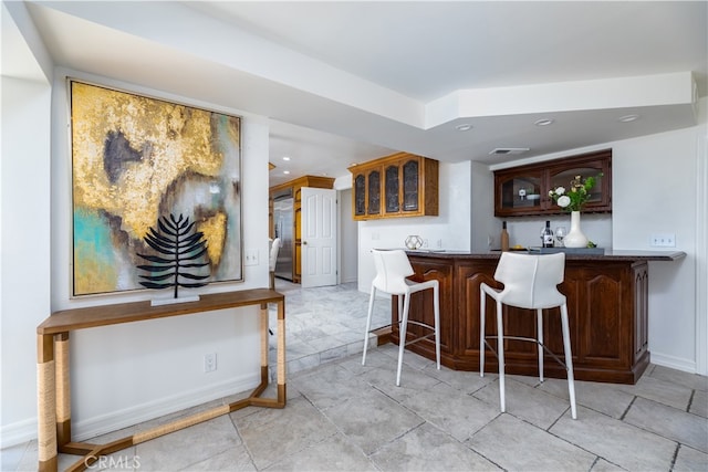 kitchen featuring a breakfast bar area and kitchen peninsula