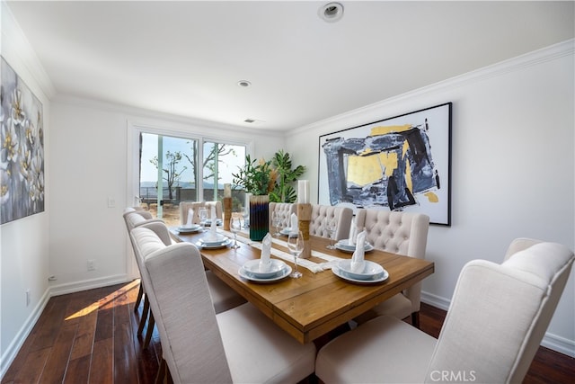 dining area featuring ornamental molding and dark hardwood / wood-style floors