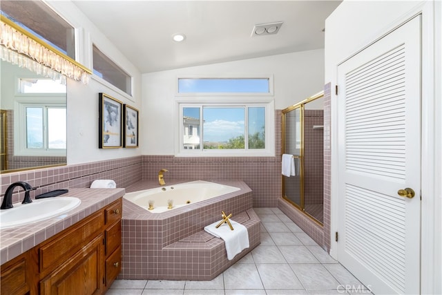 bathroom featuring plus walk in shower, plenty of natural light, and vanity