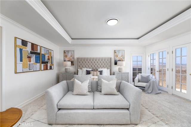 bedroom with a raised ceiling, access to exterior, crown molding, french doors, and light colored carpet