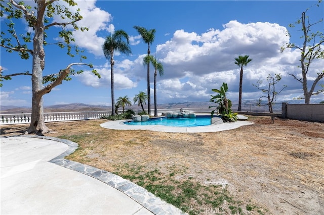 view of swimming pool featuring a mountain view and a patio area