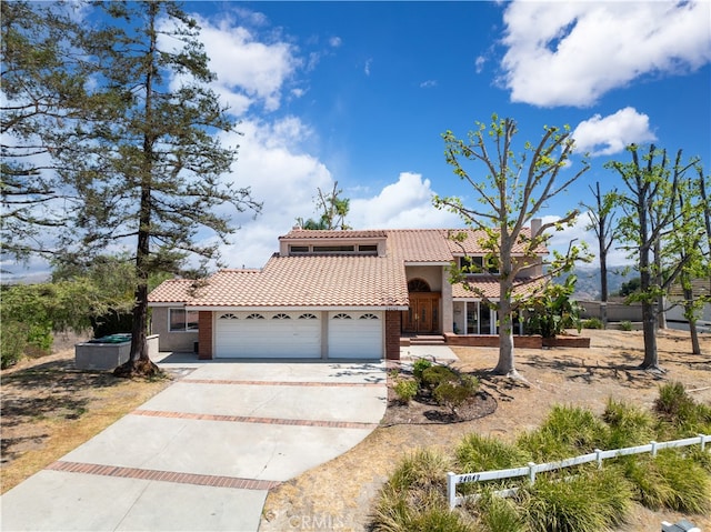 mediterranean / spanish home featuring a garage