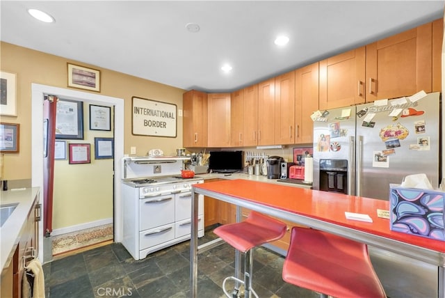 kitchen featuring white range and stainless steel refrigerator with ice dispenser