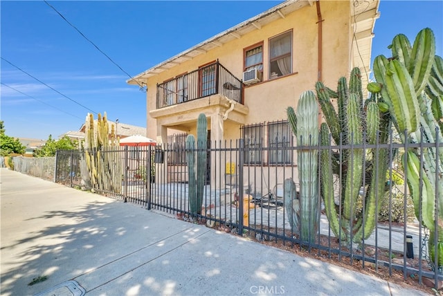 view of front of property featuring a balcony and cooling unit