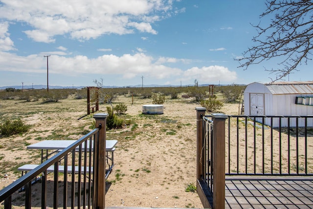 view of yard featuring a shed and a rural view