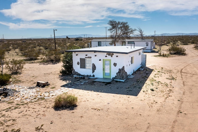 view of front of home featuring a mountain view