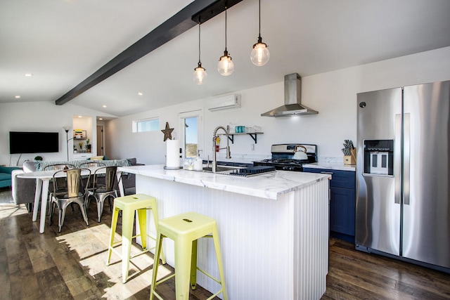 kitchen featuring hanging light fixtures, dark hardwood / wood-style flooring, stainless steel appliances, a center island with sink, and wall chimney range hood