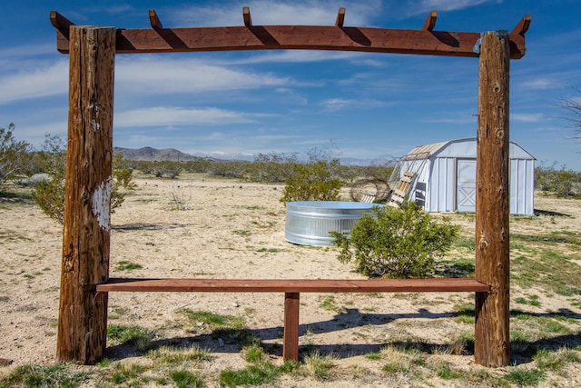 view of yard with a mountain view and a storage shed