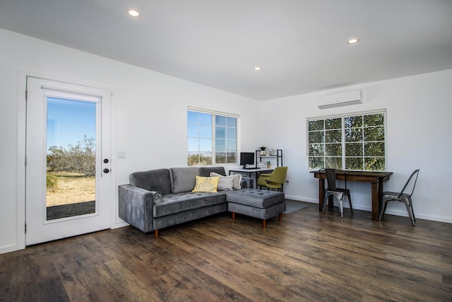 living room with dark hardwood / wood-style flooring and an AC wall unit