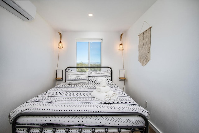 bedroom featuring a wall unit AC