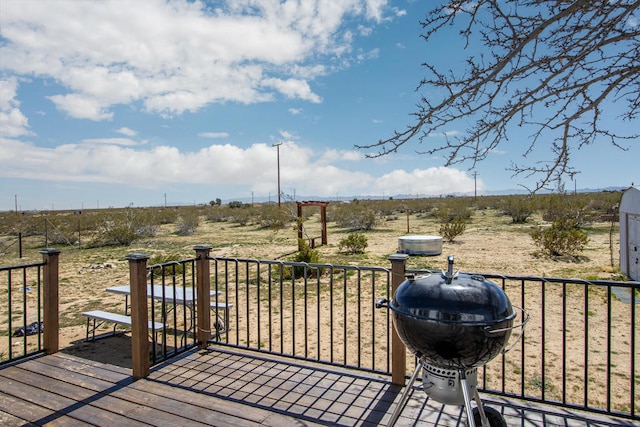 wooden terrace featuring a rural view and a grill