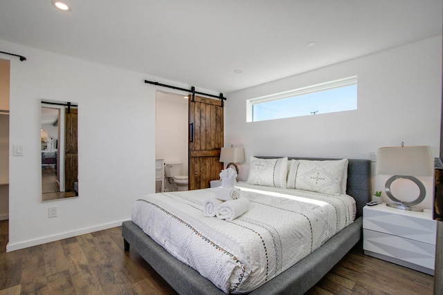 bedroom featuring dark wood-type flooring and a barn door