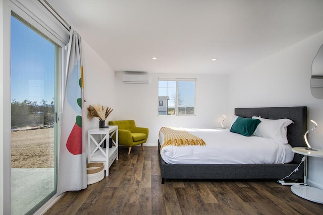 bedroom featuring an AC wall unit, dark hardwood / wood-style floors, and access to exterior