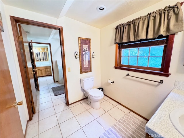 bathroom with vanity, tile patterned flooring, and toilet