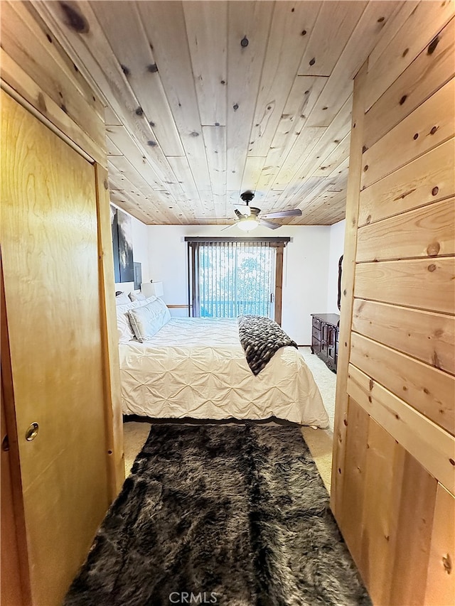 carpeted bedroom featuring wood ceiling