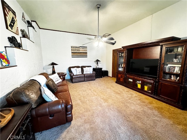 carpeted living room with ceiling fan and lofted ceiling