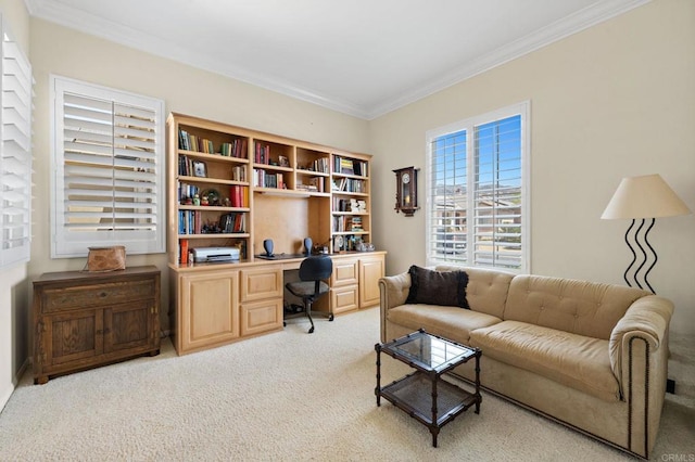 office space featuring crown molding, built in desk, and light colored carpet