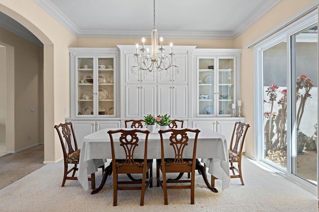 dining room with arched walkways, light carpet, a chandelier, and crown molding