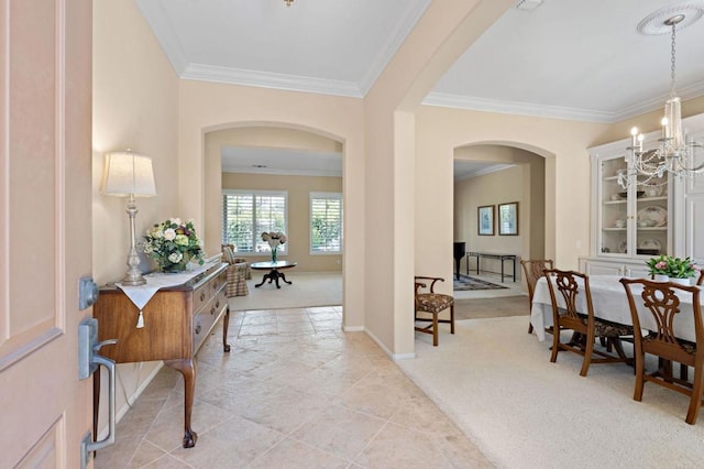 interior space featuring light carpet, a chandelier, arched walkways, and crown molding